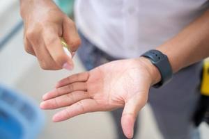 Men's hands use hand sanitizer, hand wash gel, spray pump to clean and get rid of epidemic viruses. photo