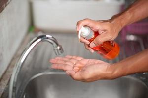 Men's hands are showing ways to wash their hands with a cleaning gel to prevent infectious diseases and prevent the virus. photo