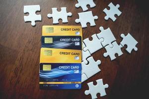 Credit cards and puzzles placed on a wooden table - business ideas photo