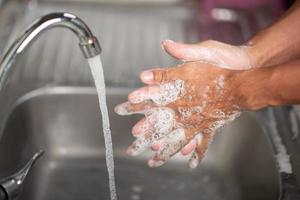 Men's hands are showing ways to wash their hands with a cleaning gel to prevent infectious diseases and prevent the virus. photo