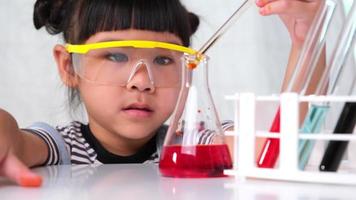 Children are learning and doing science experiments in the classroom. Little girl playing science experiment for home schooling. Easy and fun science experiments for kids at home. video