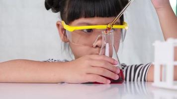 los niños están aprendiendo y haciendo experimentos científicos en el salón de clases. niña jugando experimento científico para la educación en el hogar. Experimentos científicos fáciles y divertidos para niños en casa. video