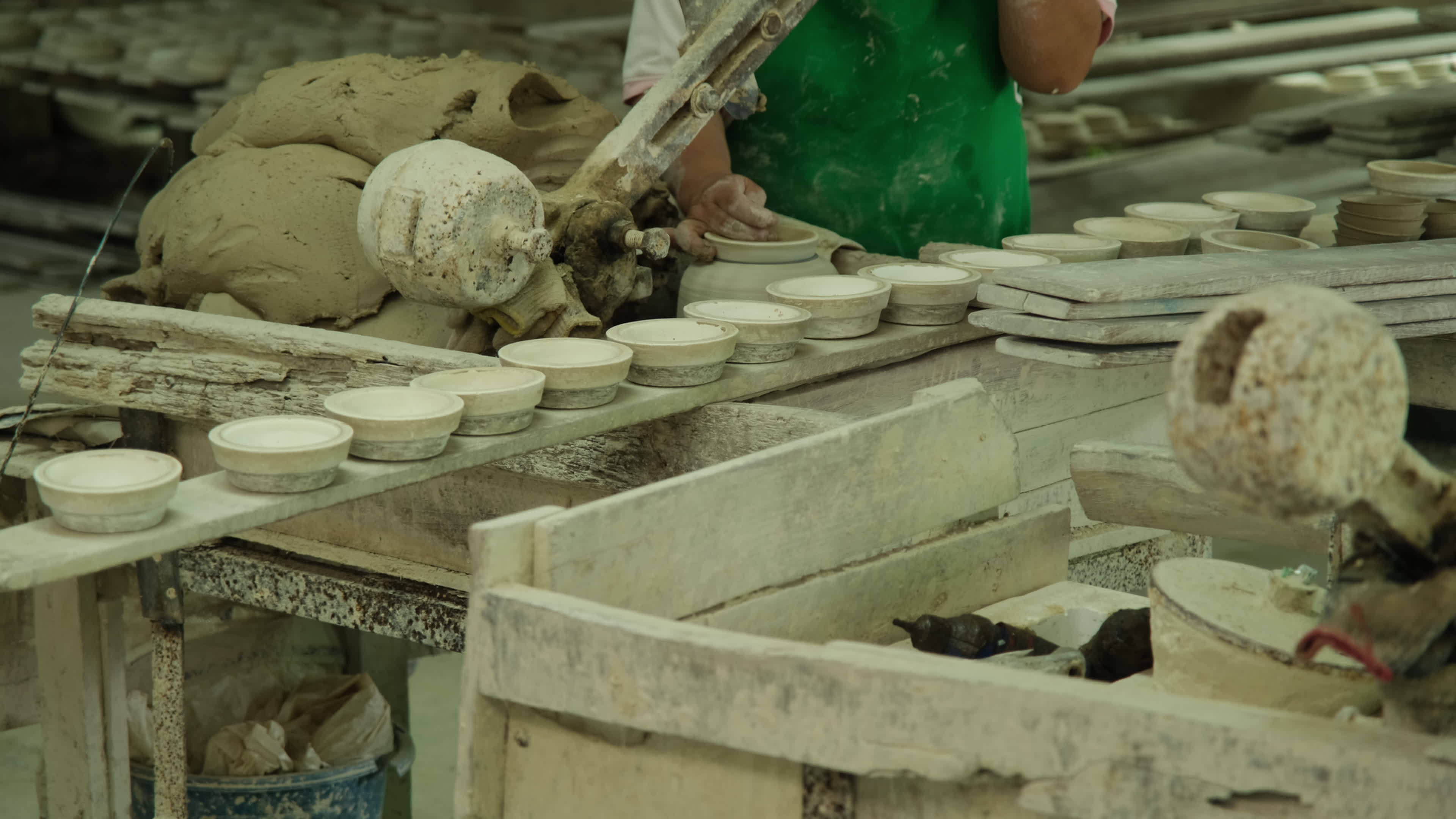 Woman making clay objects in pottery The process of making a