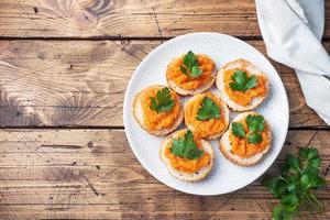 Sandwiches with bread zucchini caviar tomatoes onions. Homemade vegetarian food. Canned stewed vegetable. wooden background top view, copy space photo