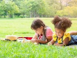 A group of young children of many nationalities play and learn outside of school photo