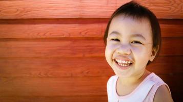 Asian girl little toddler child laughing and looking at camera. photo