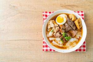 paste of rice flour or boiled Chinese pasta square in clear soup photo