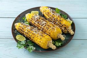 barbecue and grilled corn with cheese and lime photo