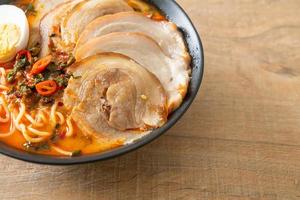 Ramen Noodles Spicy Tomyum Soup with Roast Pork photo