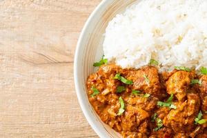 chicken tikka masala with rice on plate photo