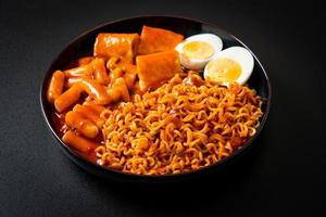 Korean instant noodles with Korean rice cake and fish cake and boiled egg photo