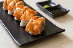 grilled salmon sushi roll with sauce photo