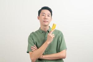 young Asian man holding credit card photo