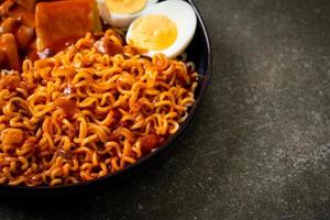 Korean instant noodles with Korean rice cake and fish cake and boiled egg photo