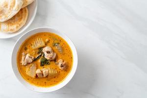Chicken curry soup with roti photo