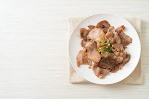 grilled pork neck sliced on plate photo