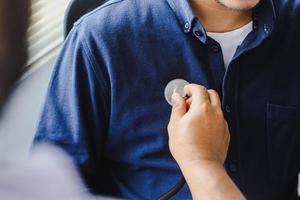 Close up of Examination of the patient with a stethoscope on the patient's chest photo