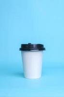 White paper cup isolated on blue background. Realistic set mock up for branding,  template for your design, presentation, promo, ad. photo