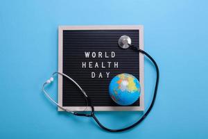 Creative flat lay composition of world health day on pastel blue background photo