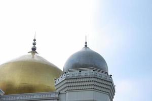 Gold and silver mosque dome under the sky with copy space photo