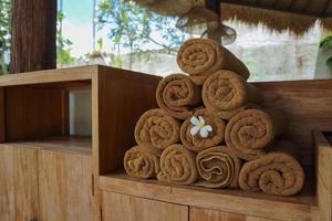 Brown spa towels arranged at lounge of swimming pool photo