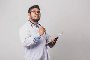 Male doctor with thinking expression isolated on white background photo