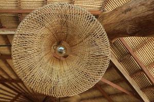 Rustic and vintage traditional rattan lamp at old roof photo