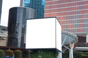 Mock up billboard with copy space surrounded by office building for advertisement and branding products. photo