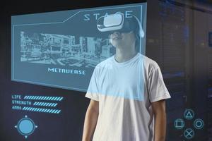 Young man using VR googles with hologram interface screen, playing virtual games on metaverse. photo