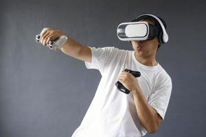Young man is boxing and using VR to work out and play the game. photo