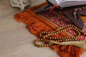 Composition of Muslim worship equipment on a wooden background photo