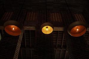 Perspective line of lamp on wicker rattan at dark room photo