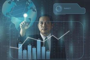 Double exposure Businessman pointing dot on globe and market chart. futuristic business concept photo