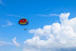 Parasailing above the ocean at tropical islands. Holiday fun activities. Copy space for tourism and love relationship photo