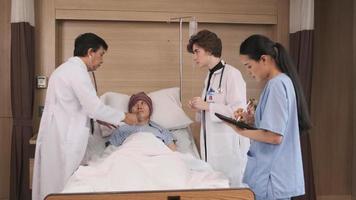 Professional doctors team in uniform health check Asian recovery male patient by stethoscope, medicine treatment at inpatient room bed in hospital ward, medical clinic, cancer examination consult. video