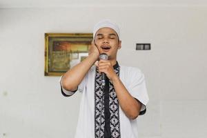 Religious Muslim man doing the call to prayer photo