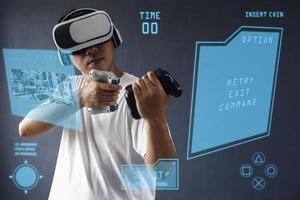Young man seriously playing virtual games on metaverse, using VR googles and consoles with hologram interface screen. photo