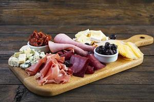 Italian antipasto. Antipasti board with ham, salsami, prosciutto, parmesan, blue cheese and olives. photo