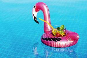 Fresh coctail mojito on inflatable pink flamingo toy at swimming pool. Vacation concept. photo