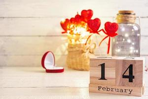 Valentine day. Wooden calendar with February 14 on it. photo