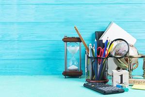 Different school supplies on blue background. Concept Back to school photo