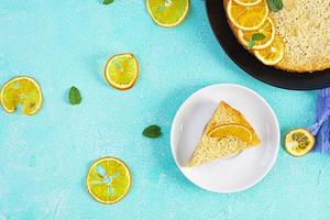 Delicious homemade orange tart on blue background photo