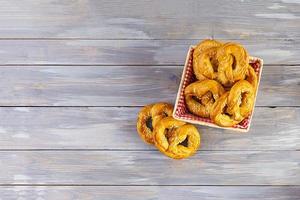 Homemade baked salt pretzel on wooden background. Oktoberfest concept photo