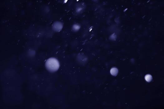 Blue abstract bokeh that is blurred and mixed with small circles photo