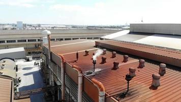 Aerial view of roof of old factory around with red rust cause from pollution gas. video