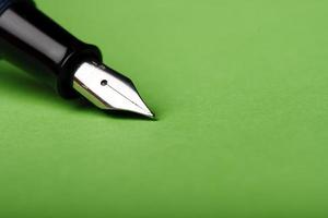 Fountain pen closeup on green background photo