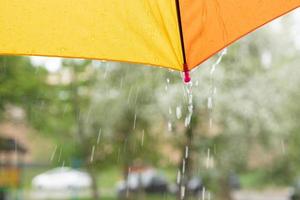 The edge of a colored umbrella and raindrops photo