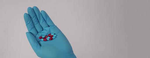 Taking or holding medication pills in hand. Capsule pill on white background. photo