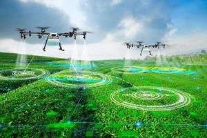 Agriculture drone scanning area to sprayed fertilizer on green tea fields, Technology smart farm 4.0 concept photo