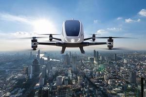 Autonomous driverless aerial vehicle flying on city background, Future transportation with 5G technology concept photo